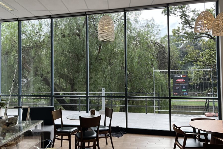 Floor to ceiling shopfront glass cleaned inside a commercial cafe space