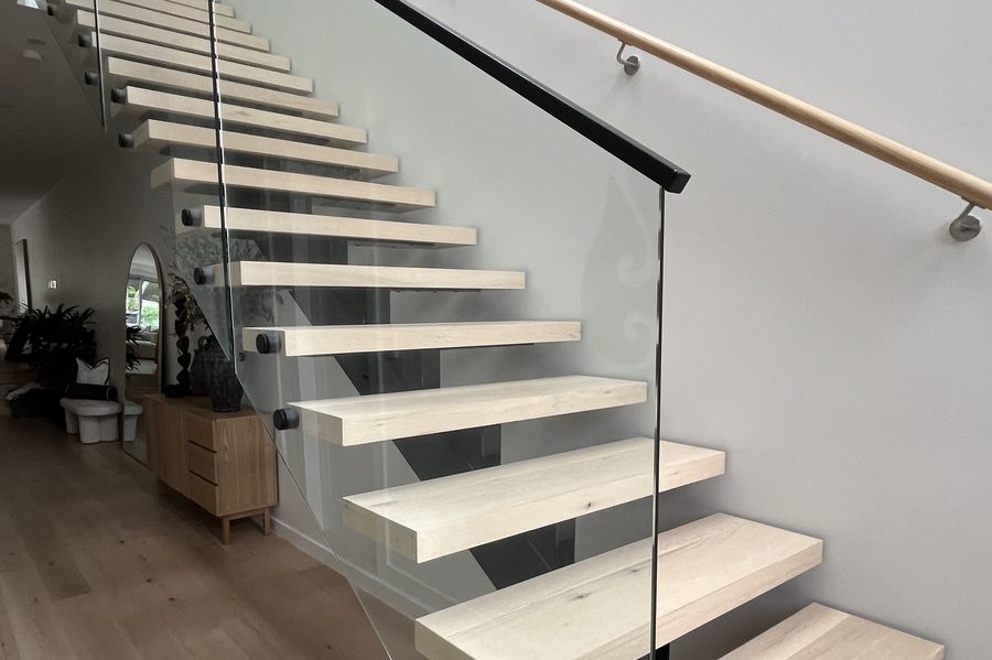 Frameless glass balustrade on a timber staircase, cleaned on both sides