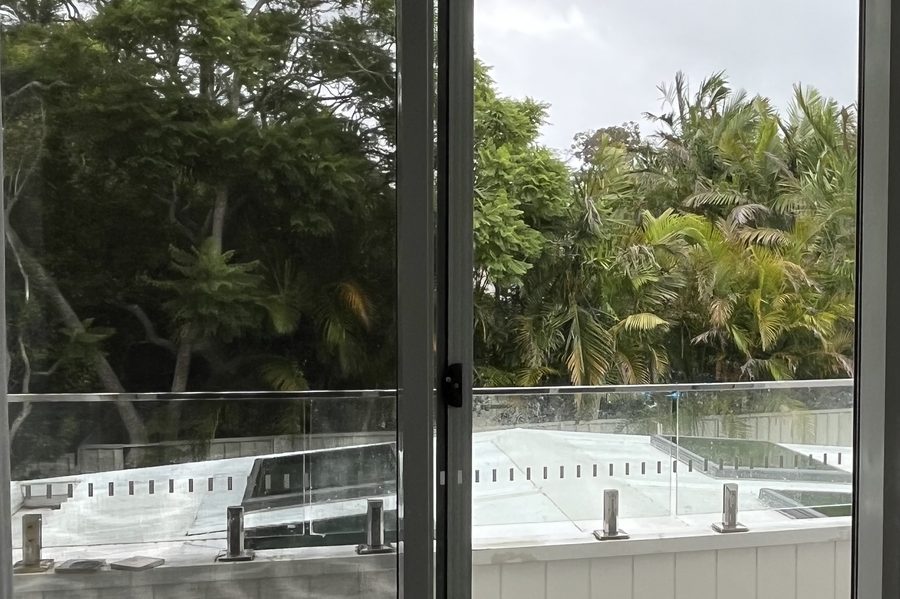 Sliding door and flyscreen washed and refitted, looking out to a pool terrace